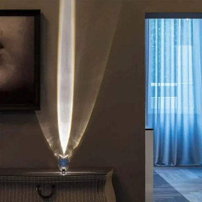 Crystal Atmosphere Lamp Elegant Ambient Lighting Modern lamp with a feather design casting light on a wall next to a window with blue curtains.