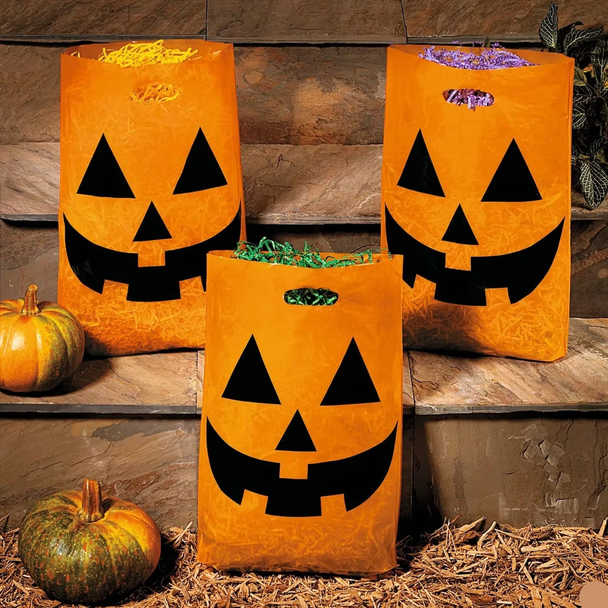 Orange Plastic Halloween Candy Bags Pack of 50 with Pumpkin Face and Cutout Handle for Large Hauls