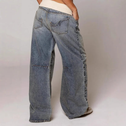 Light blue Y2K baggy wide leg jeans for women, featuring a stylish ribbed waist and unique curved seam.